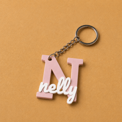 Customized name medals featuring each customer’s name and initial, creating a unique personalized accessory designed especially for them, light pink and white