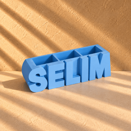 Customized light blue 3D-printed name pen holder, personalized with your chosen name in English, perfect for a desk or office.  