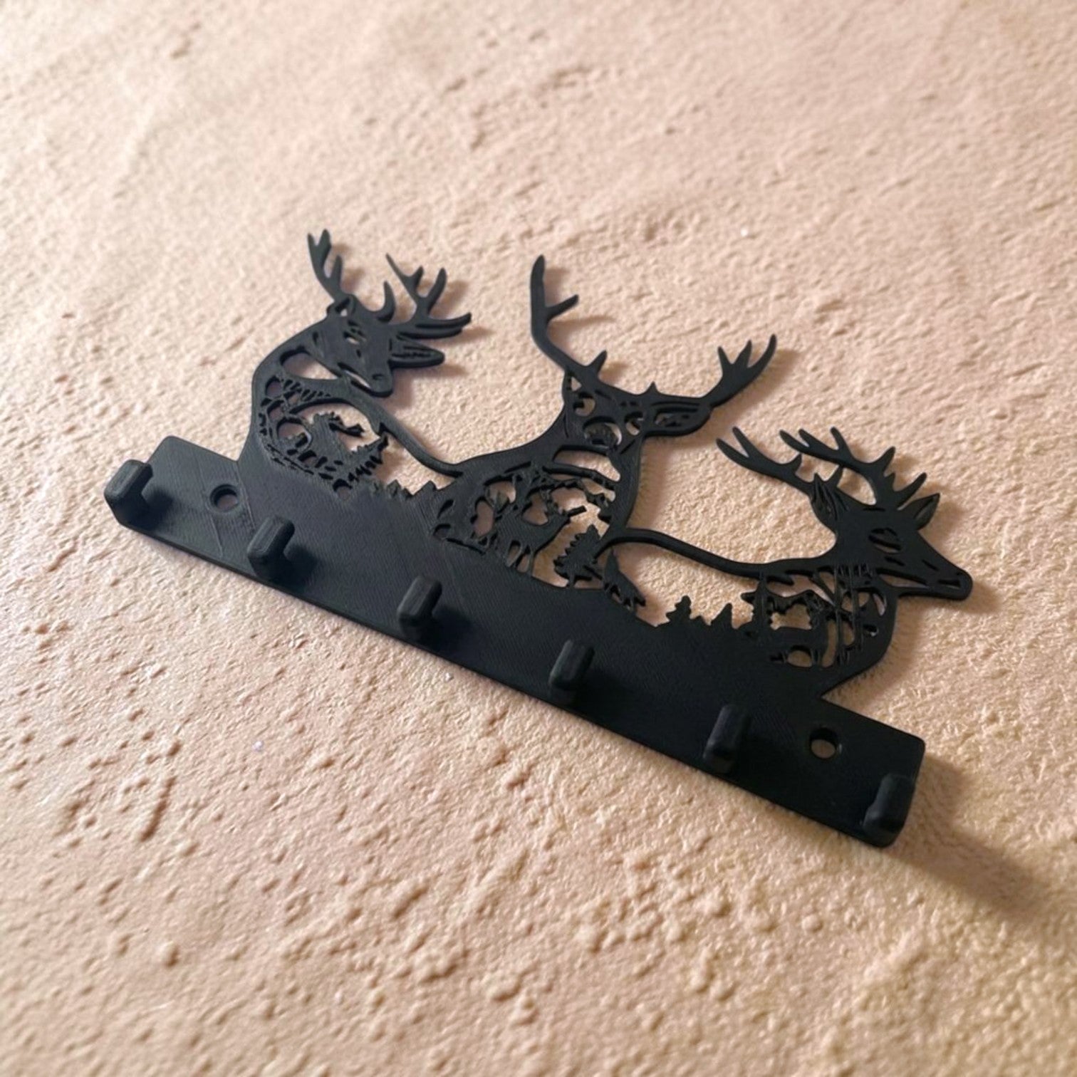 Deer-shaped keychain holder featuring a decorative design for neatly organizing and displaying keys, combining practical storage with stylish home décor.