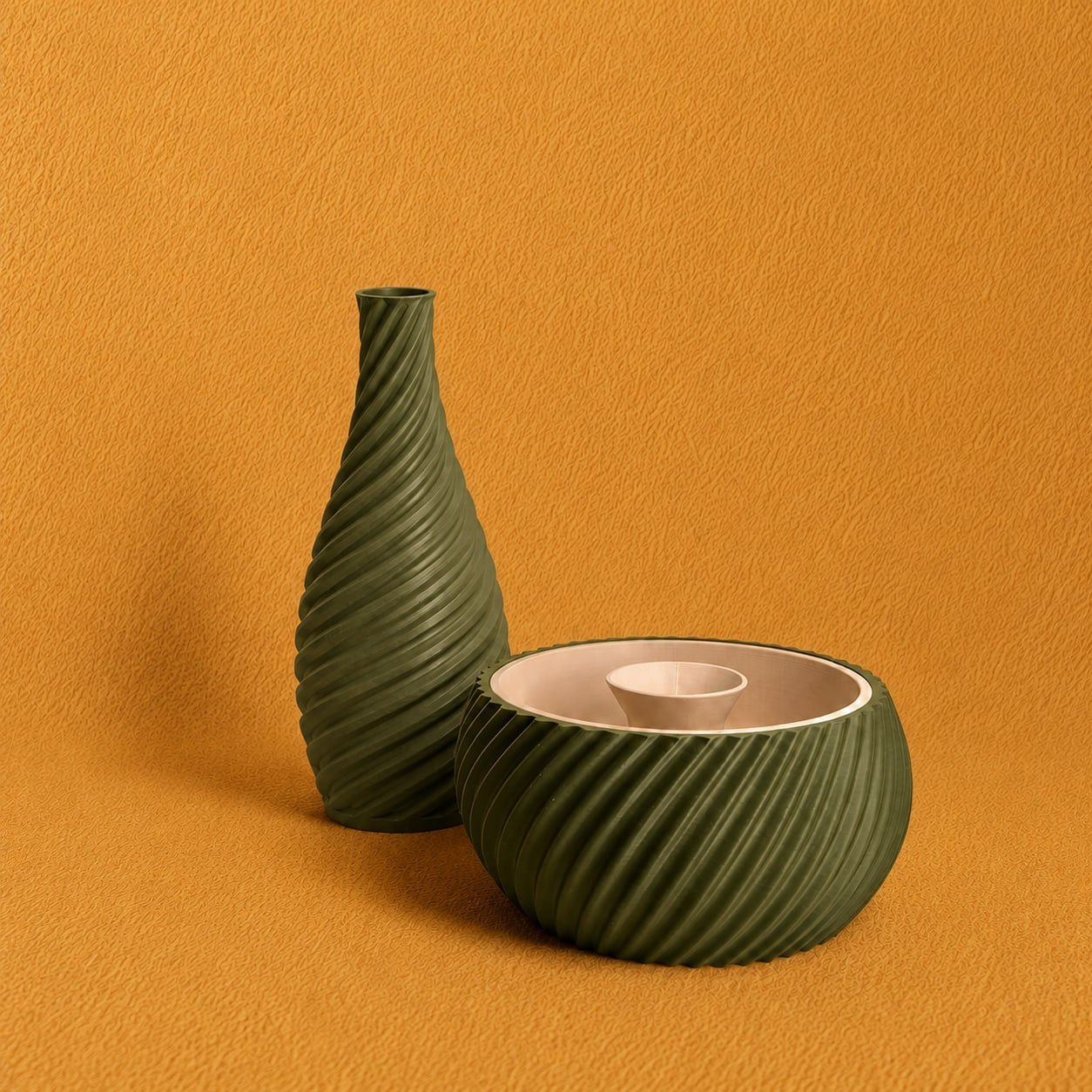 Shell & Seed and Spiral Vase bundle featuring an olive green ribbed Shell & Seed piece with an ivory interior alongside an olive green spiral-textured vase on a warm textured background.