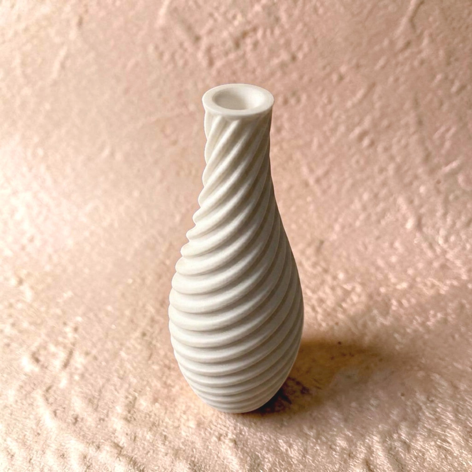 Spiral vase collection featuring elegant sculptural curves and a modern twisted design, perfect for flowers or as stylish decorative pieces for any space.