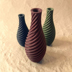 Spiral vase collection featuring elegant sculptural curves and a modern twisted design, perfect for flowers or as stylish decorative pieces for any space.