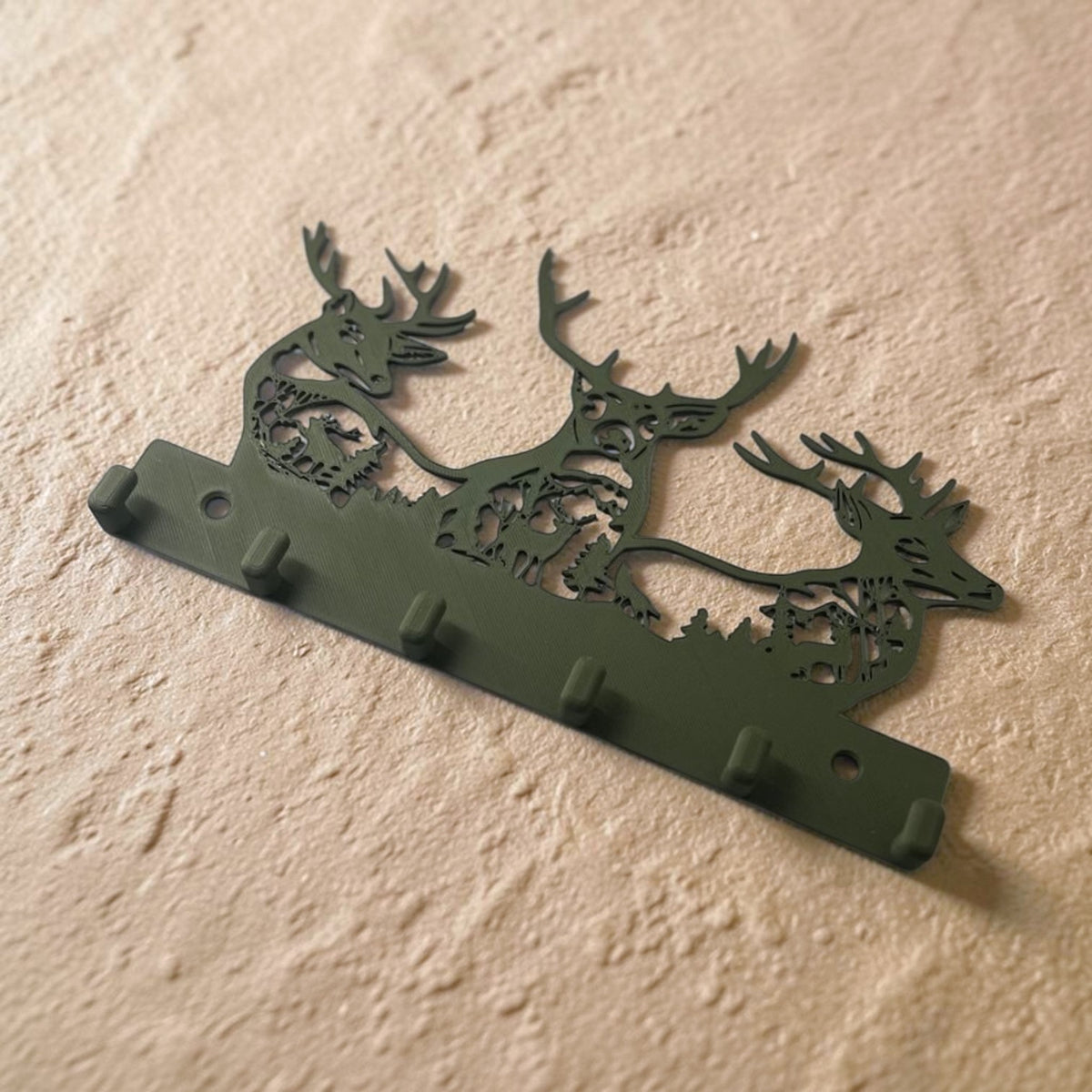 Deer-shaped keychain holder featuring a decorative design for neatly organizing and displaying keys, combining practical storage with stylish home décor.